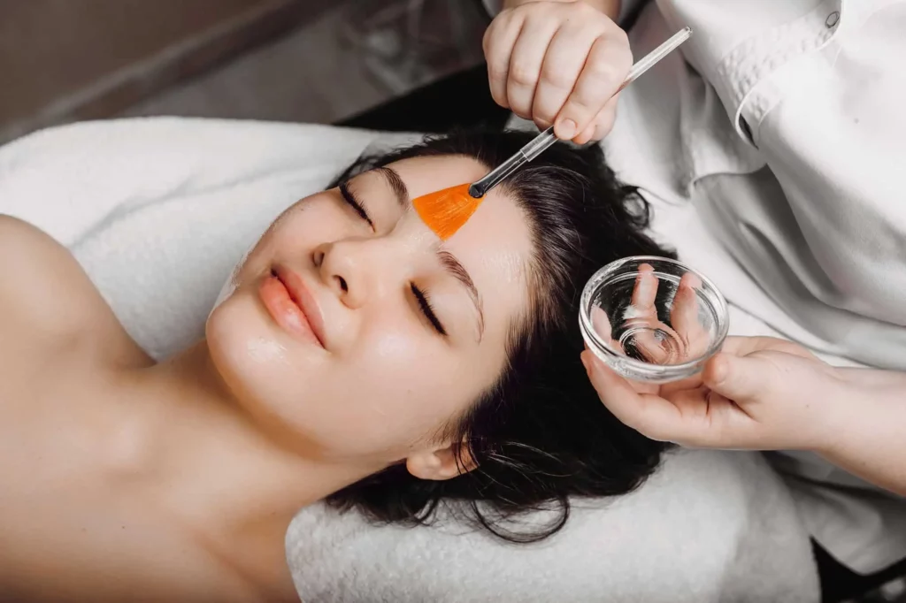 a woman receiving a chemical peel