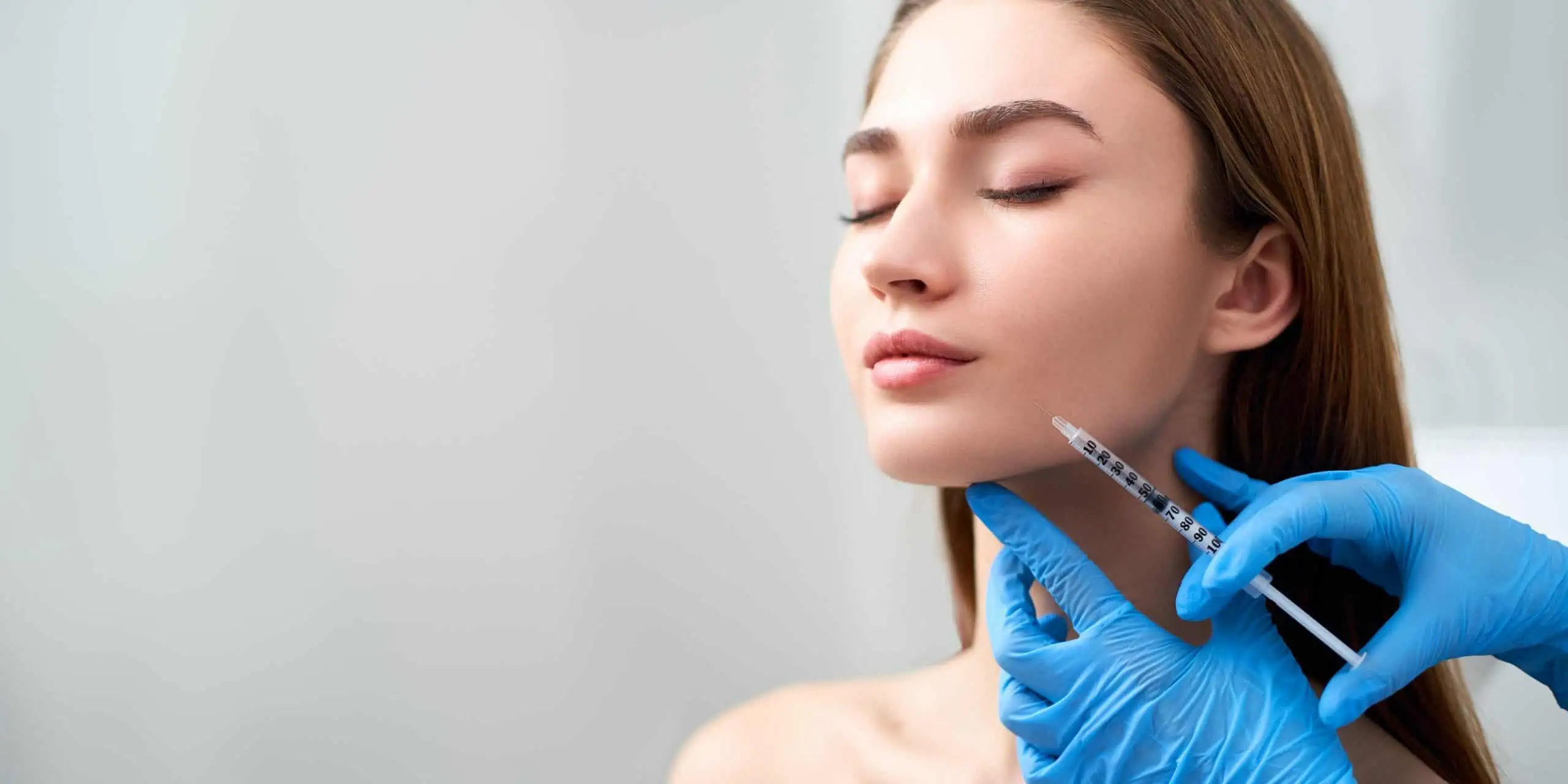 a woman getting dermal filler injection